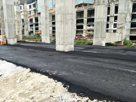 Asphalt paving beneath a viaduct — Muhibah Konsortium Holdings civil works